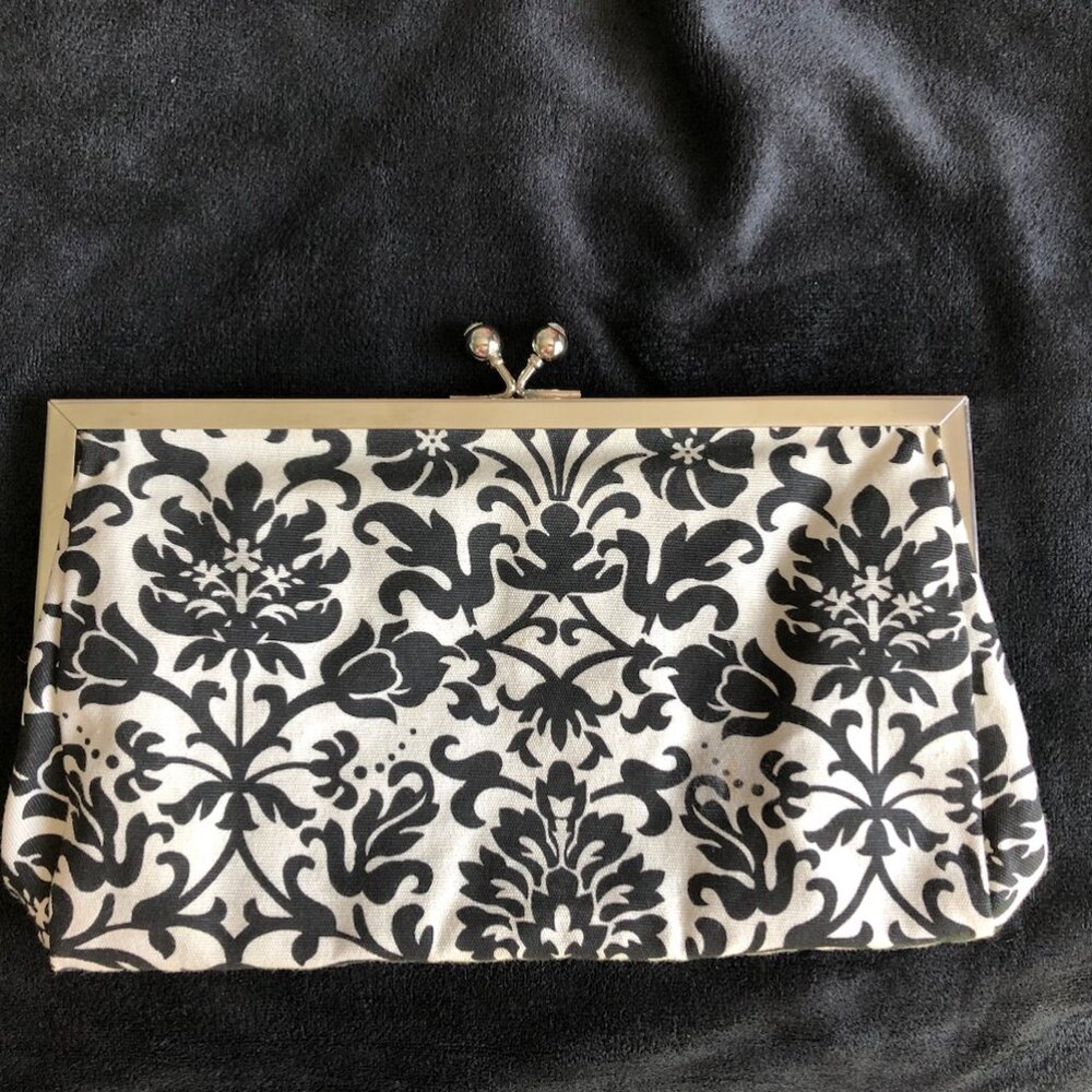 Black and white floral clutch with silver trim and rhinestone ball clasp
